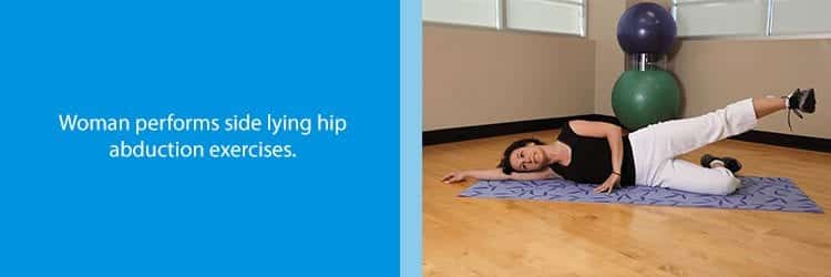 Woman performs side lying hip abduction exercises for piriformis syndrome.