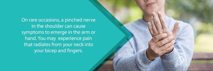 woman with hand pain from pinched nerve in shoulder