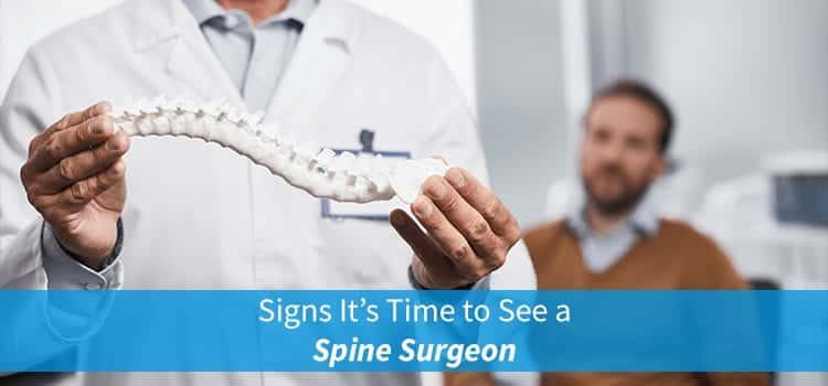 spine surgeon with patient