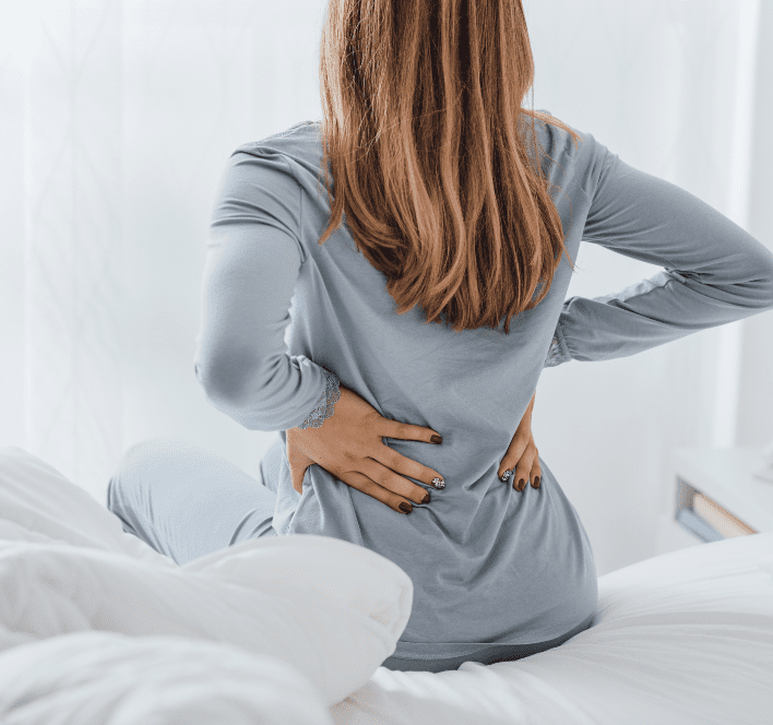 Woman is holding her back