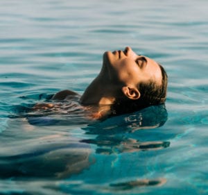 Woman Swimming in a Pool
