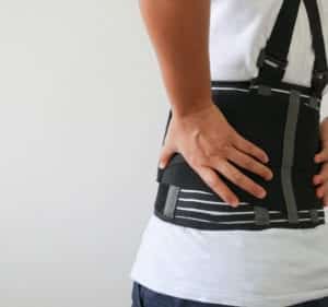 close up patient Lumbar spondylosis. Patient using a back brace after spine surgery