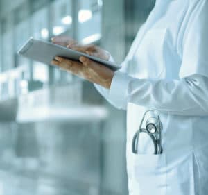 healthcare doctor scrolling through an ipad