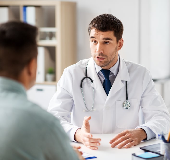 doctor talking to male patient at medical office