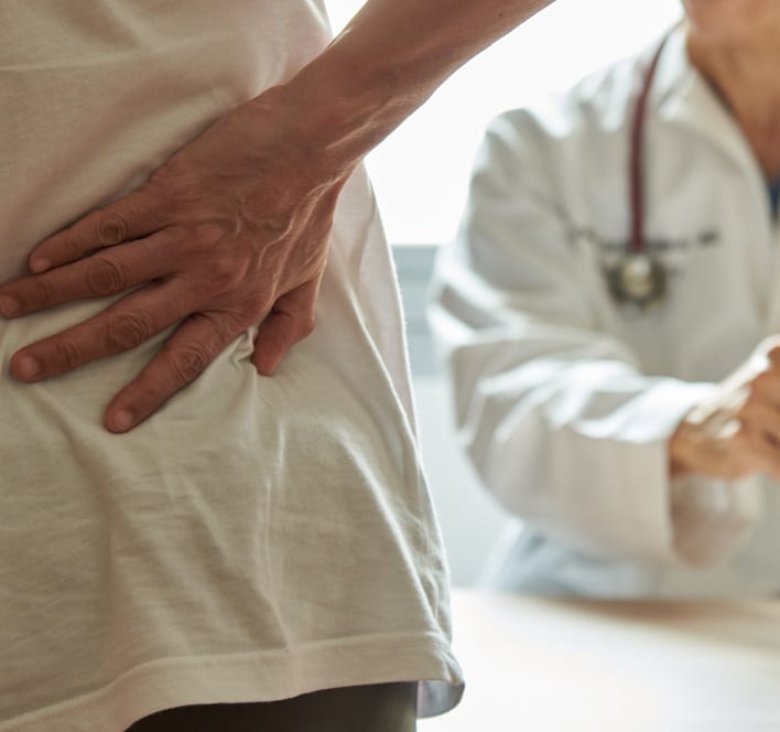 Back pain patient visiting doctor in clinic