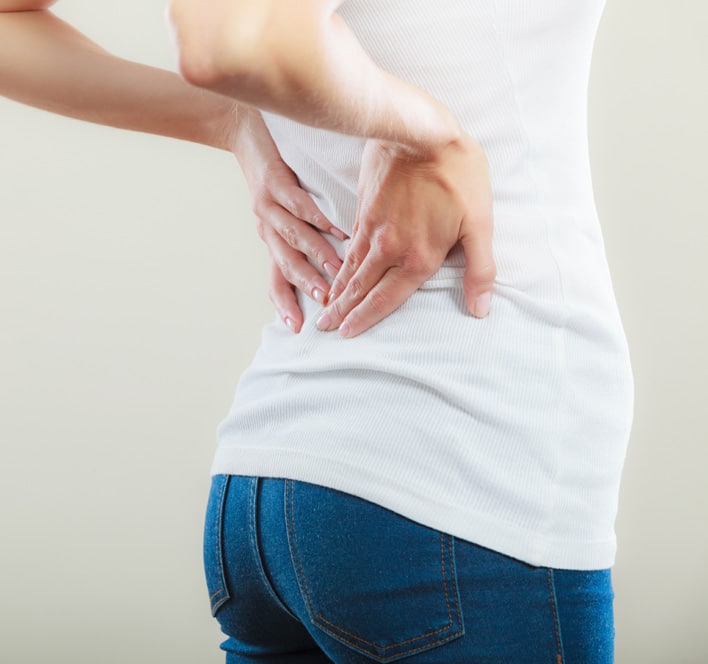 Young woman suffering from back pain