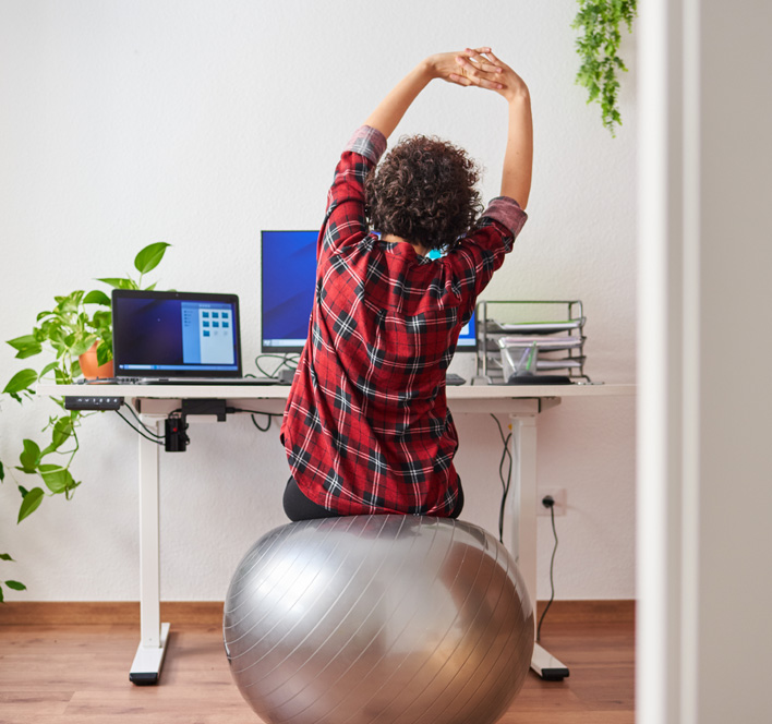 Woman stretches while working