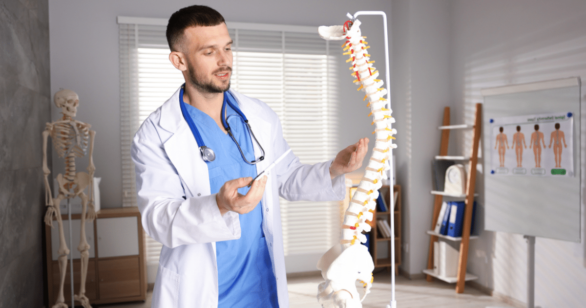 Spine specialist in New Jersey reviewing imaging with a patient for chronic back pain care.