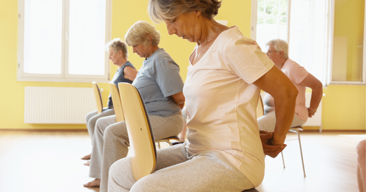 Patient experiencing lower back pain caused by muscular strain or structural spine condition.